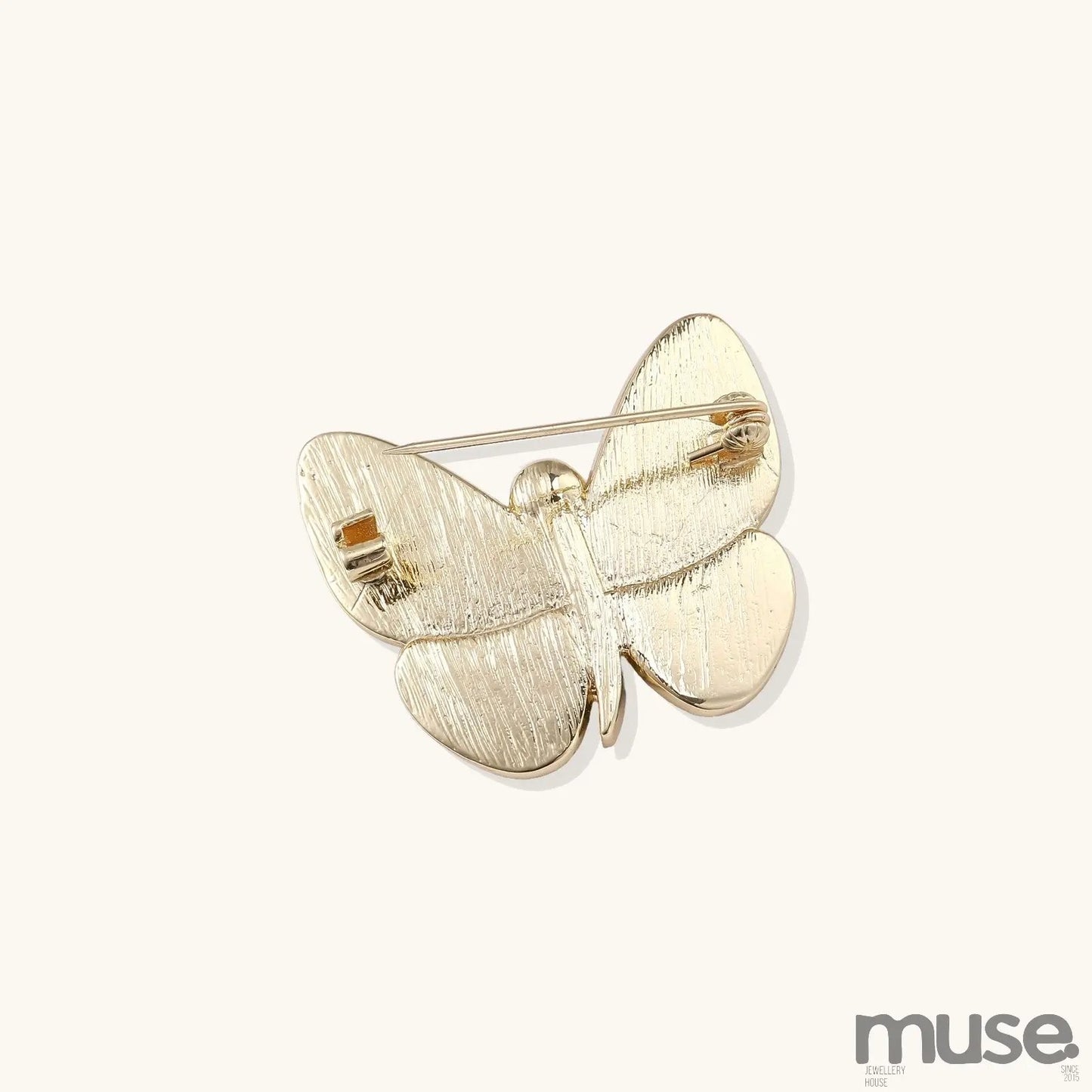 Iridescent abalone shell butterfly pin with central pearl and gold setting, showing rainbow color reflections