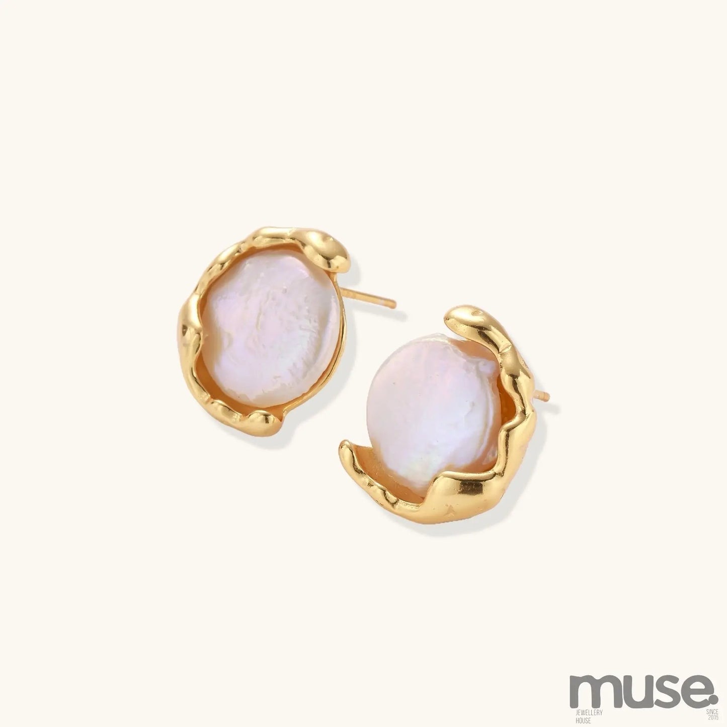 Gold-plated sterling silver stud earrings with organic claw settings cradling lustrous freshwater pearls on white background.