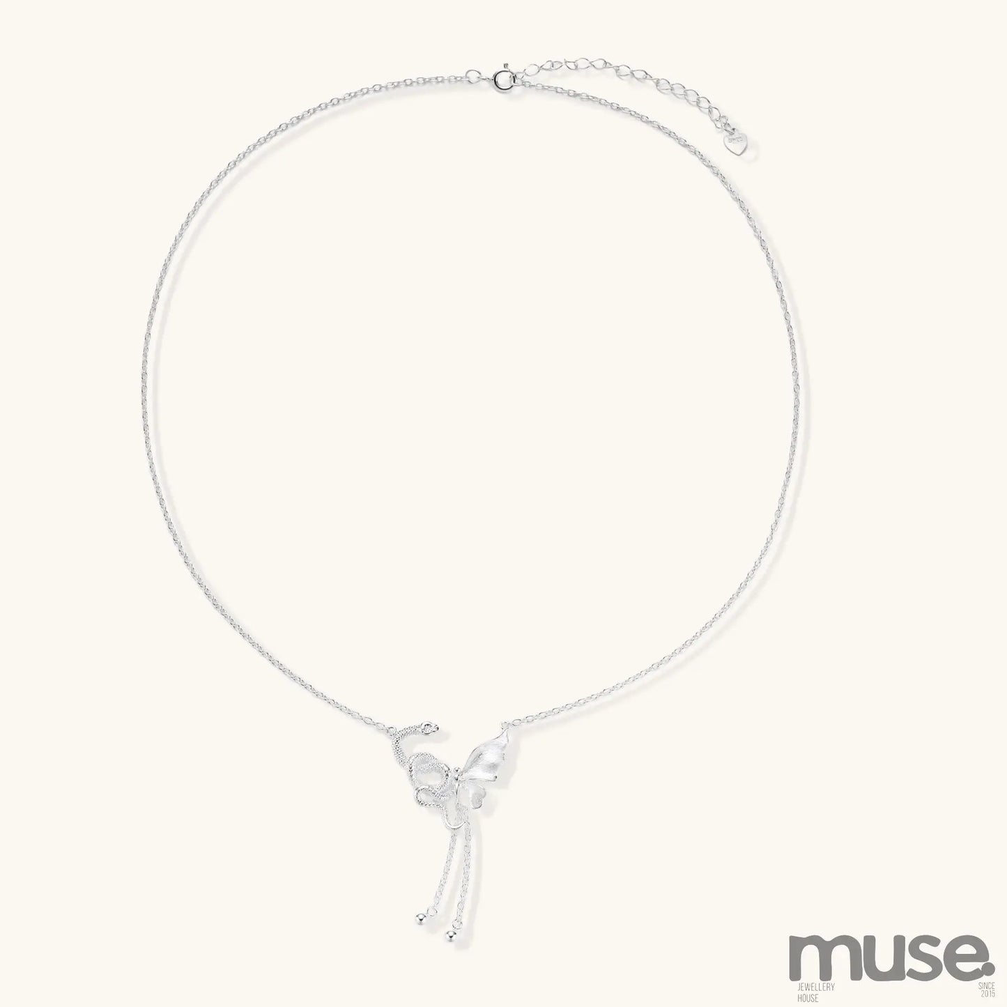 Delicate sterling silver butterfly pendant necklace with textured wing details and adjustable chain on white background