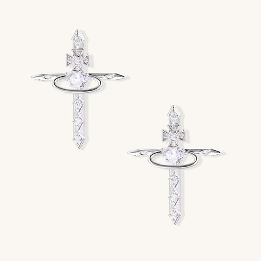 Gold-plated dangle earrings with cross tops, oval halos, and pointed bottoms adorned with clear zirconia stones