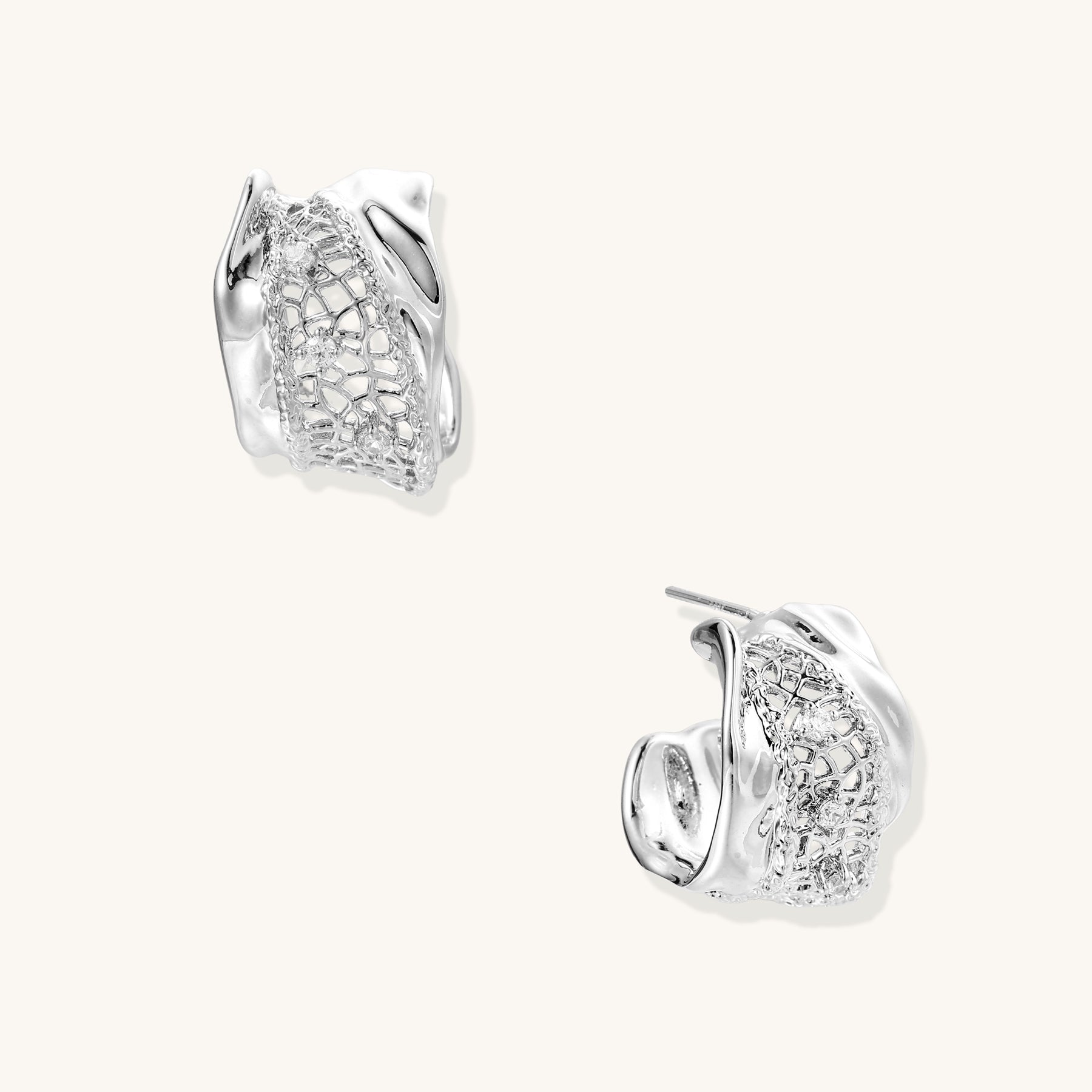 Small gold-plated brass hoop earrings with geometric lattice pattern and zirconia accents on white background.