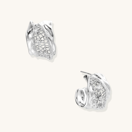 Small gold-plated brass hoop earrings with geometric lattice pattern and zirconia accents on white background.