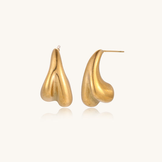 Pair of gold-plated sculptural stud earrings with organic teardrop shapes on neutral background.